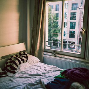 Bedroom with a Balcony Railing by Dean Merrick