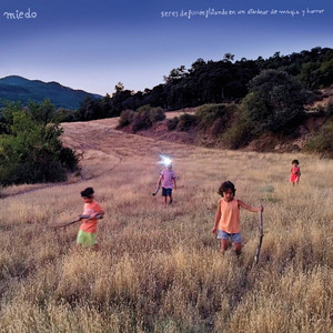album cover: Seres de ficción flotando en un atardecer de magia y horror