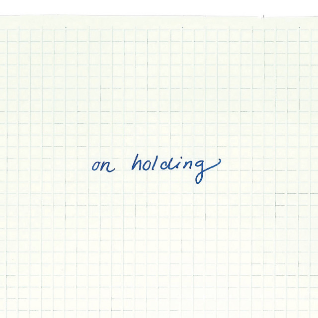 on holding cover art